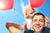 young girl sitting on daddy with two balloons.