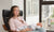 Depressed mother holding new born baby and sitting on a chair