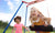 Two happy smiling little toddlers girls friends swinging on swings at playground outside