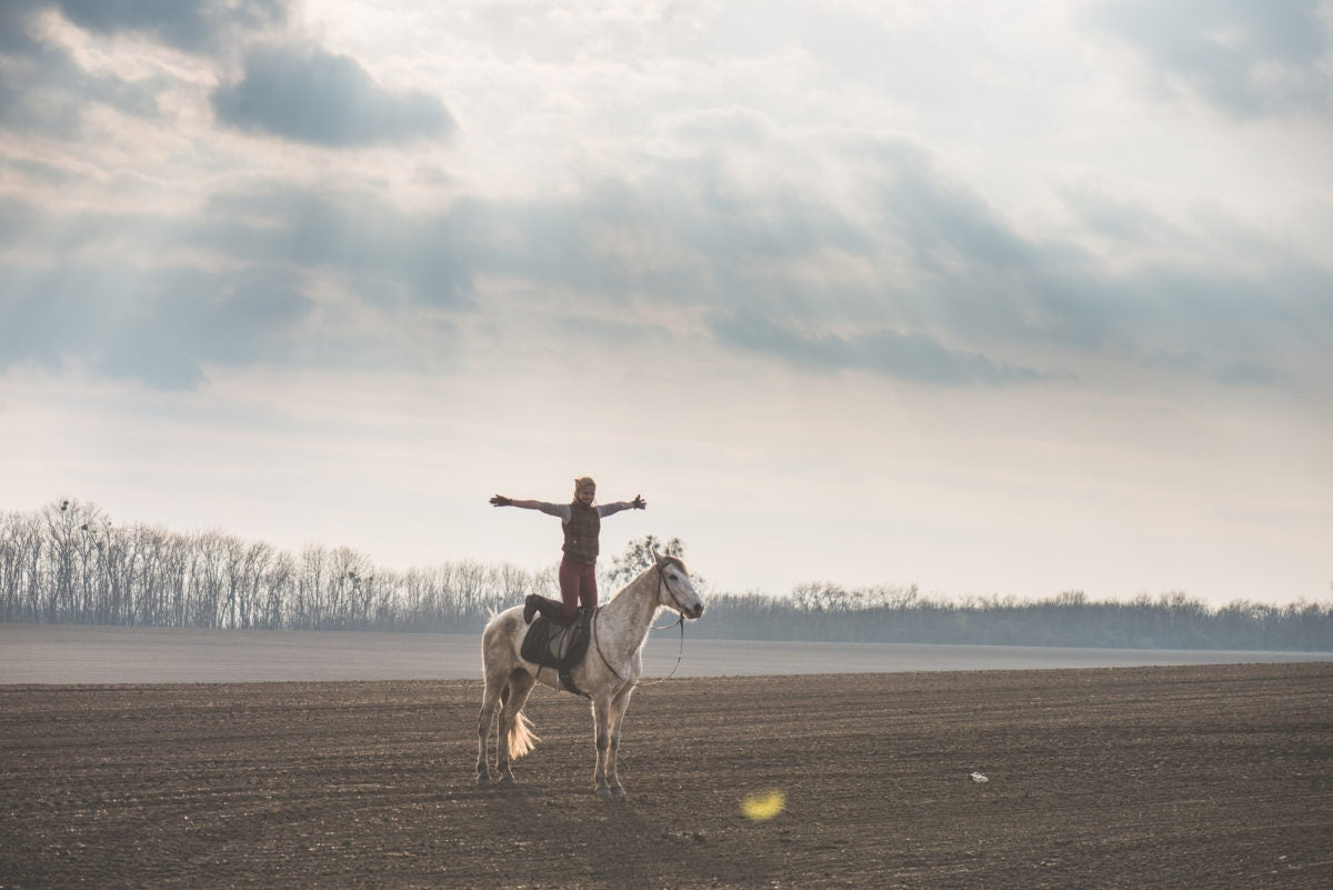 girl standing on horse