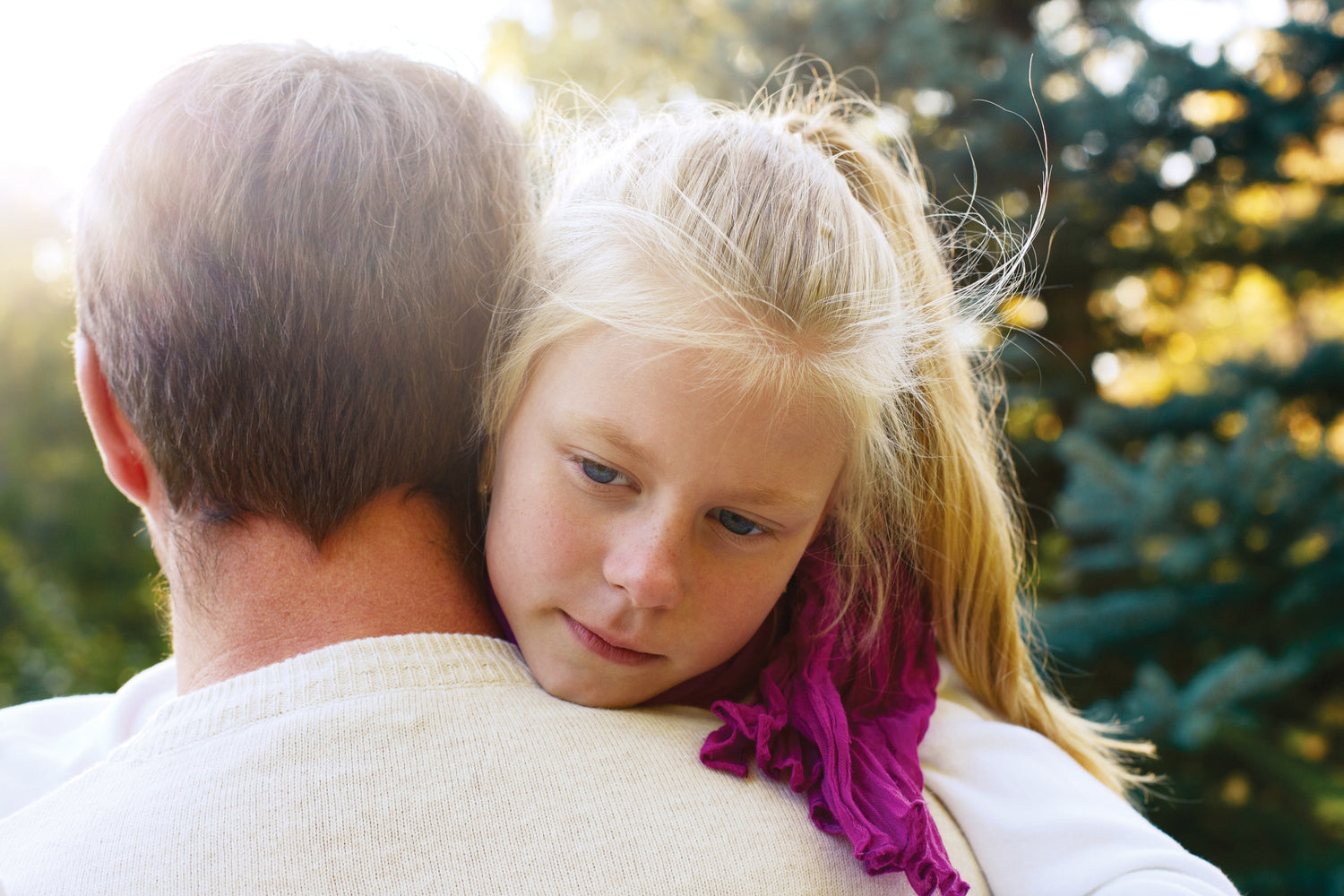A baby hugging her father