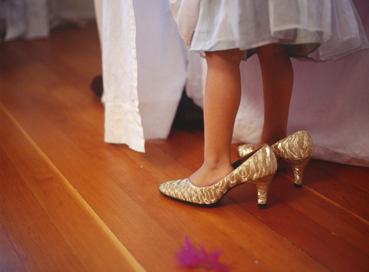 Little girl wearing mother's heels 
