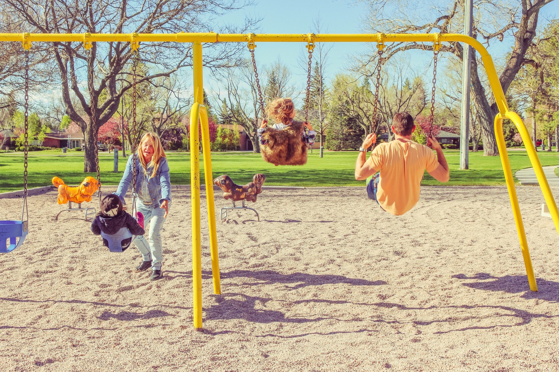 Happy family having fun together on playground