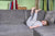 child lying on sofa with her legs straight in the air