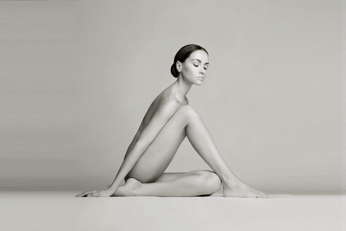 nude woman sitting on the floor