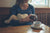 mother breast feeding cute baby in arms at cafe