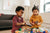 Two young sisters playing with toys on table