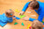 father and daughter playing with colorful papers at home