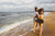 two beautiful women walking on the beach and smiling