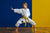 young girl practicing martial arts with a yellow belt