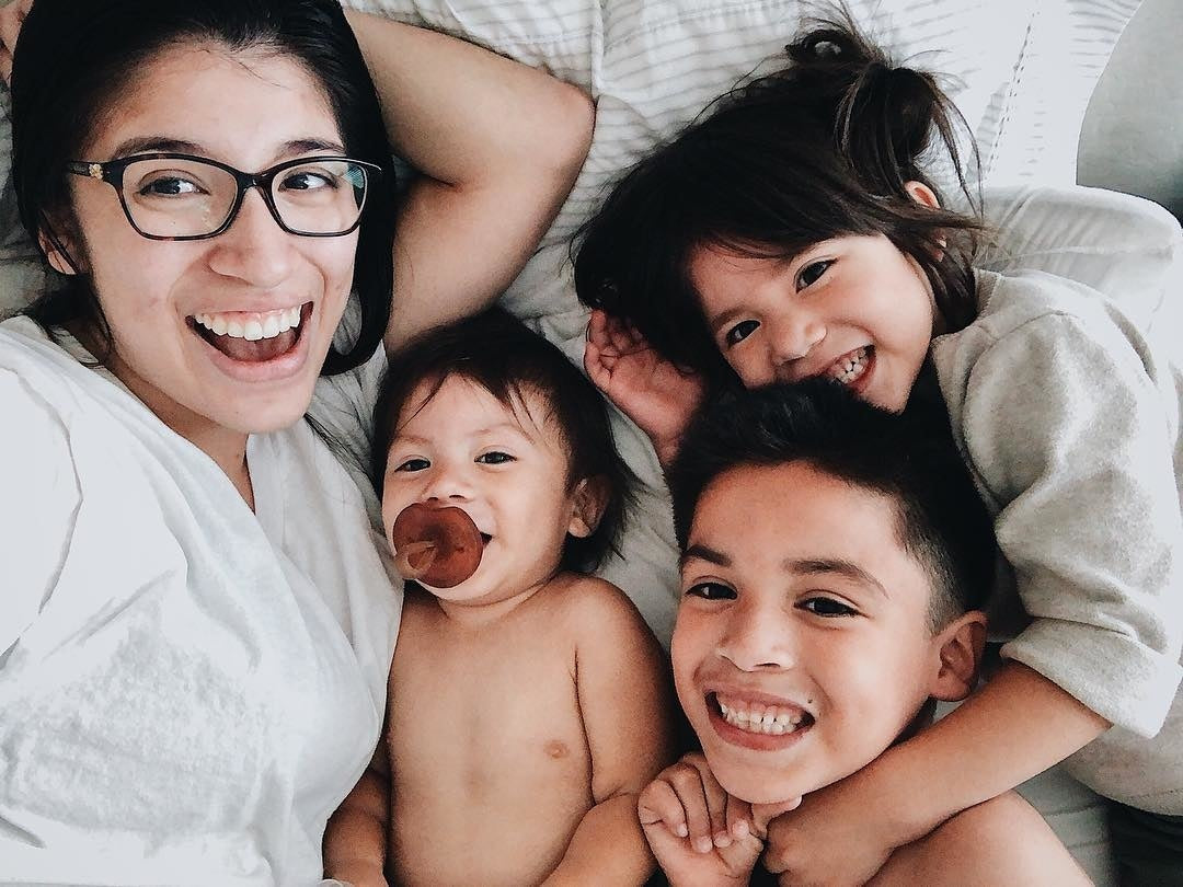 Happy mother with three children taking a selfie