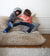 2 boys fighting on a sofa