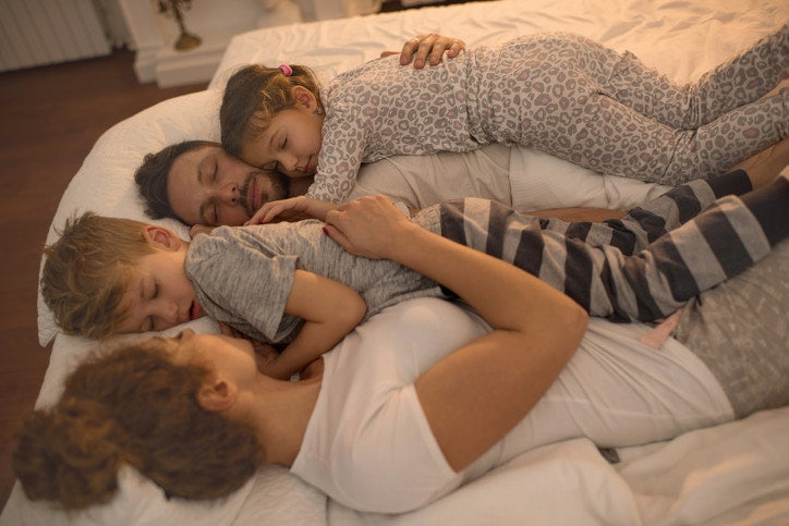 family sleeping on the comfortable bed