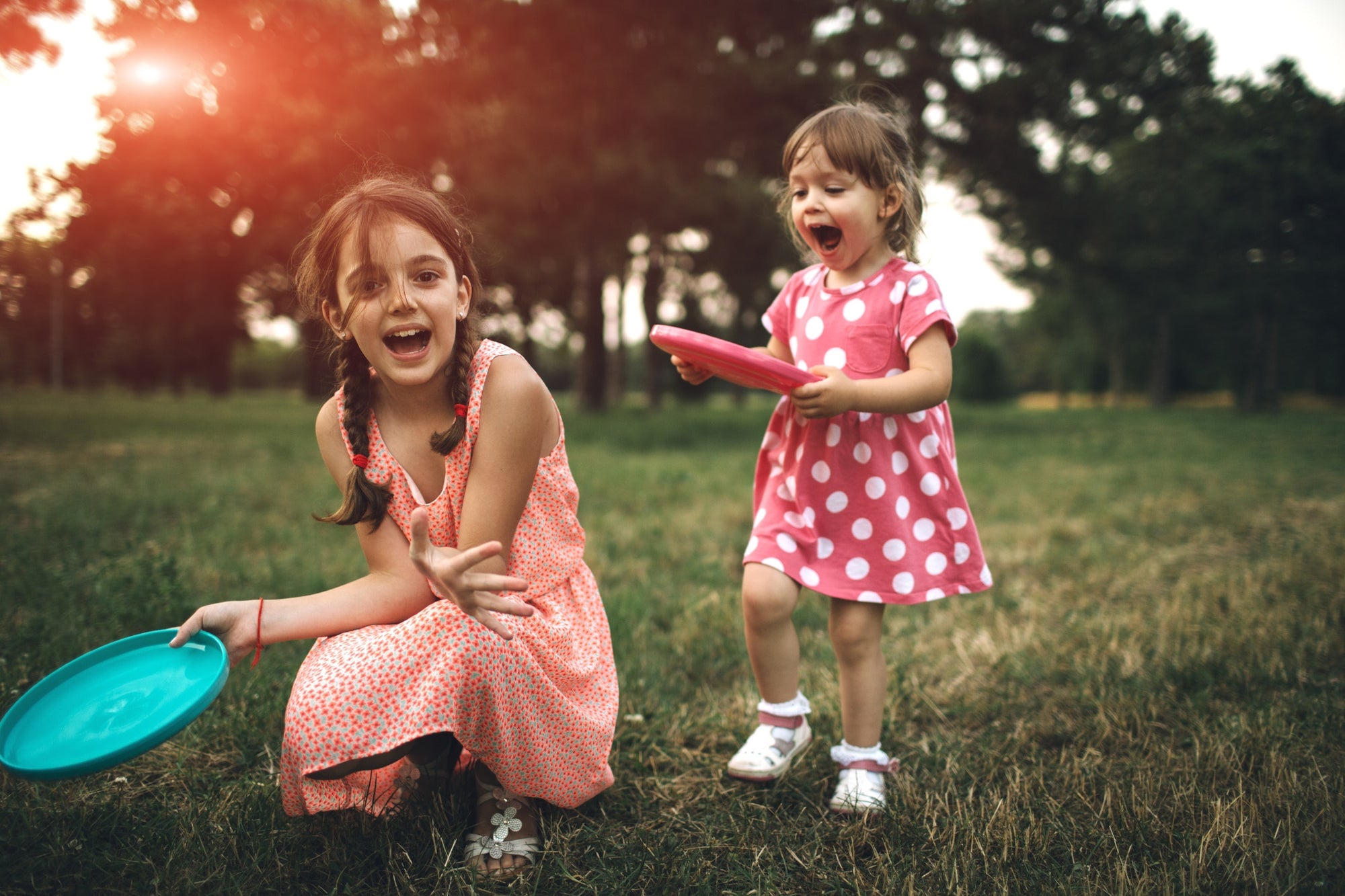 Little Girls Playing With Frisbee Toy Outdoor In Nature