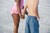 Young boy and girl holding hands while standing on beach