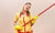 young lady teenager holding a big broom in her hands pretending it is an air guitar