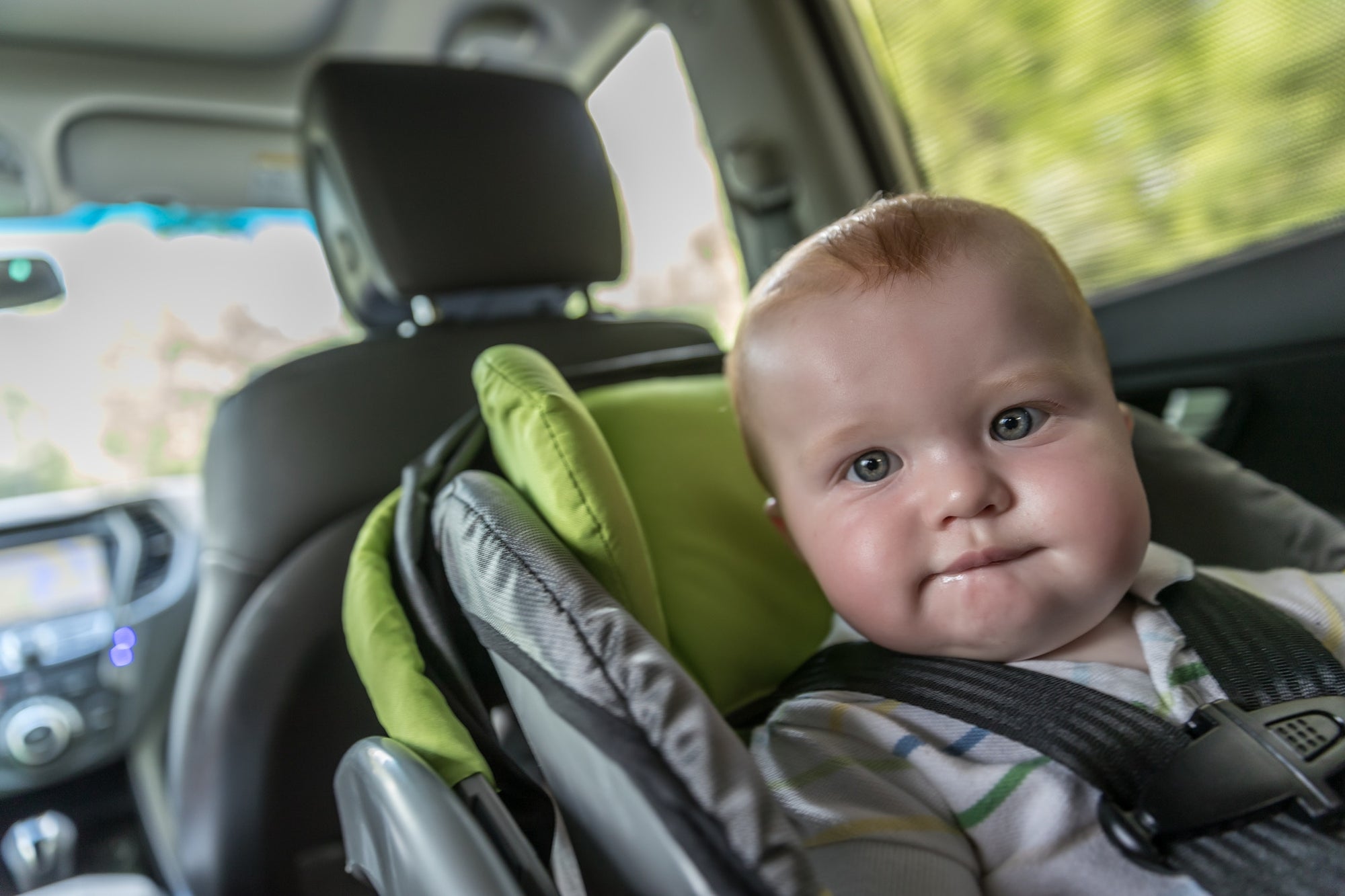 chubby baby in a child safety car seat