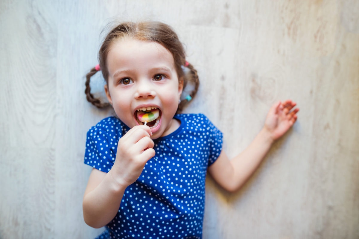 Girl eating candy lolipop