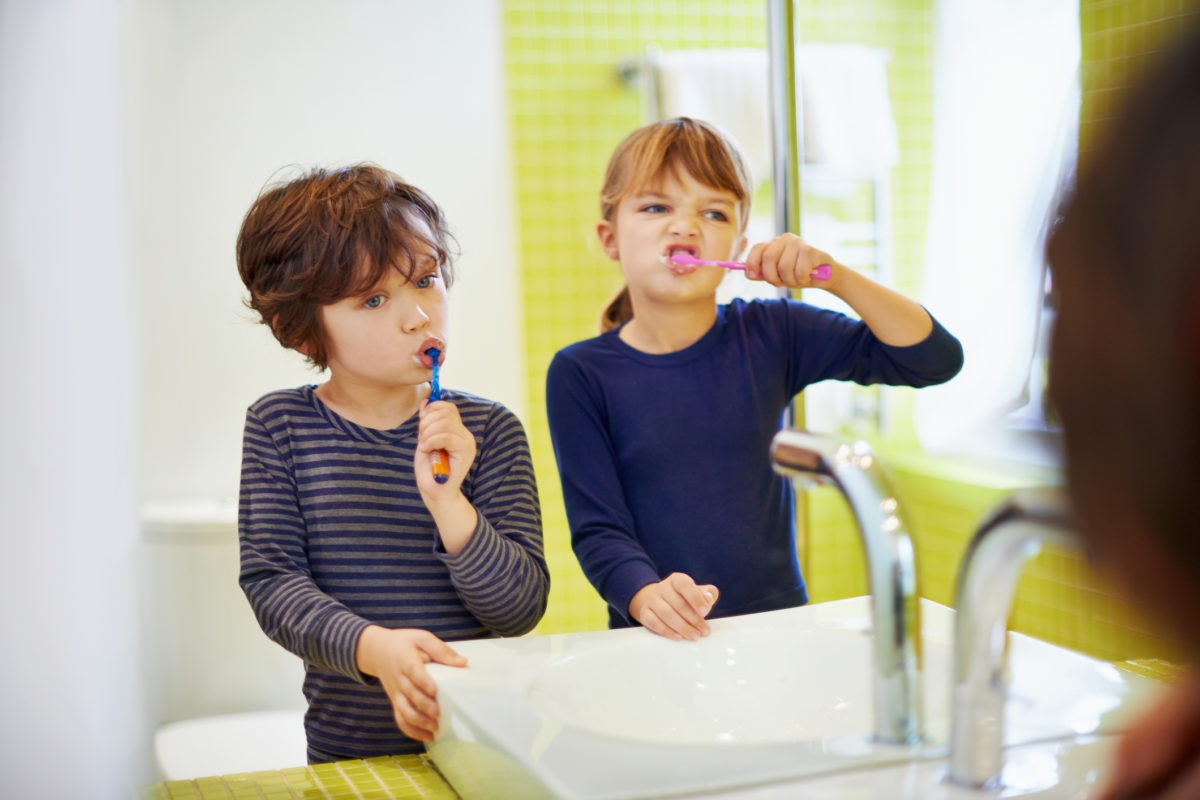 Two Kids brushing their teeth