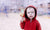 curious boy in red hoodie looking at his toy gun