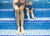 mother and son sitting in swimming pool