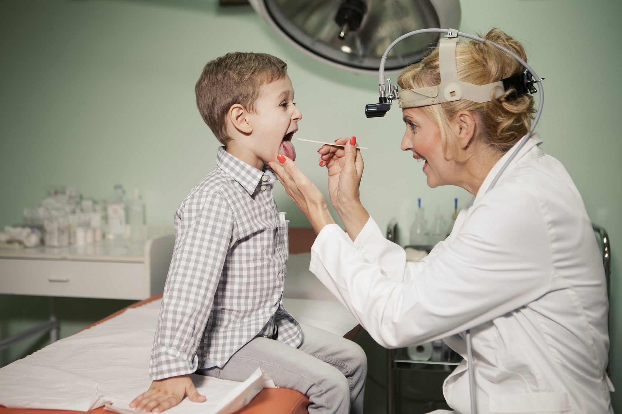 Doctor Checking Little Boys Tonsils