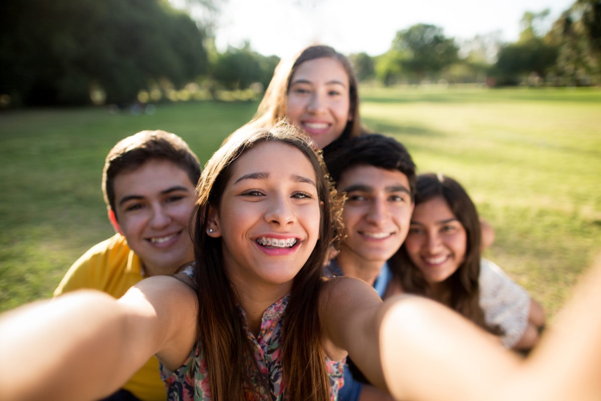group of friends taking a selfie in the park