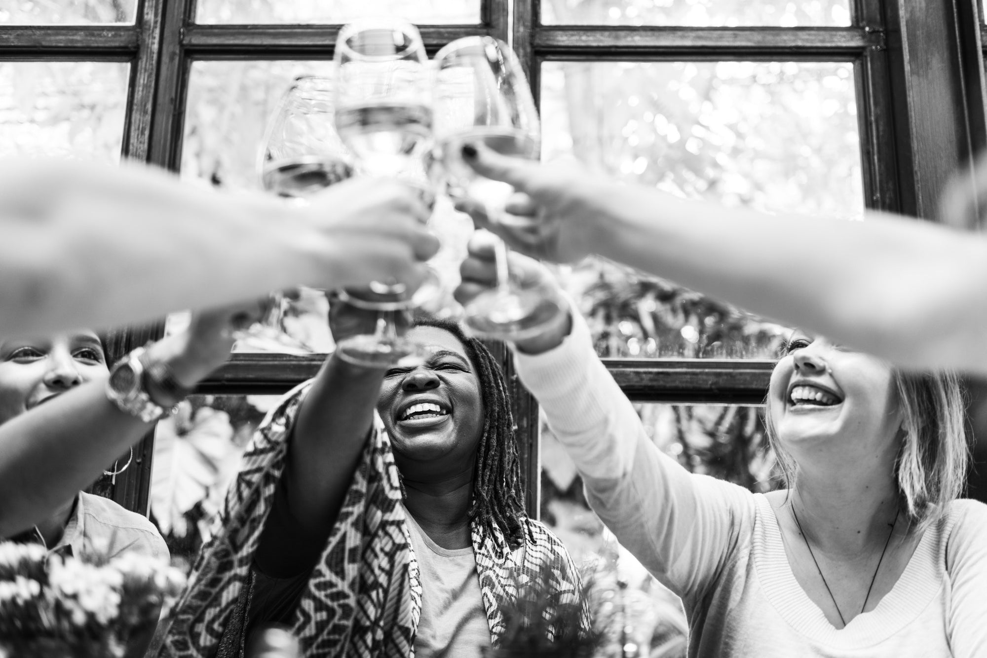Happy women Cheering With Wine Glasses