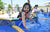 Child on a water park , splashing water fro pool