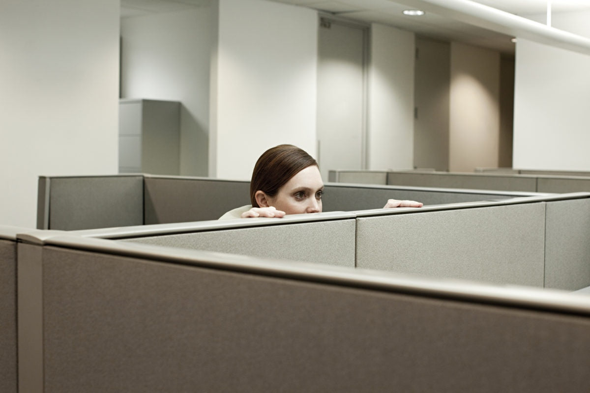 Lady hiding on the cubicle