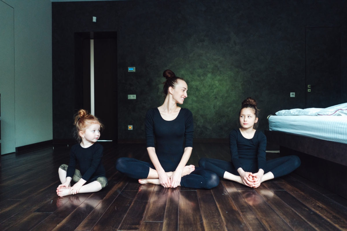 Mother and two child doing yoga