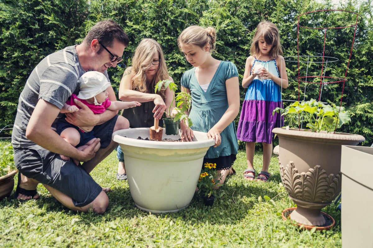 family planting plants together