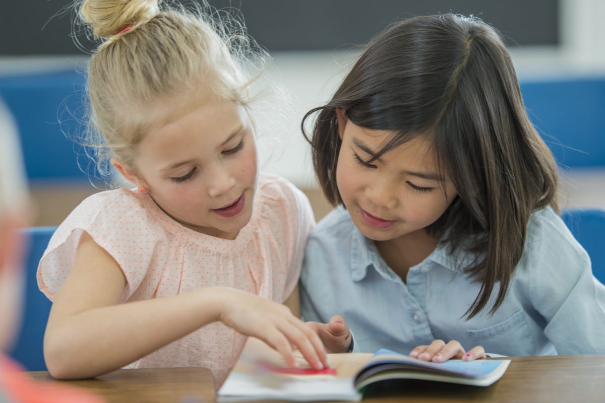 Little girls reading books in school