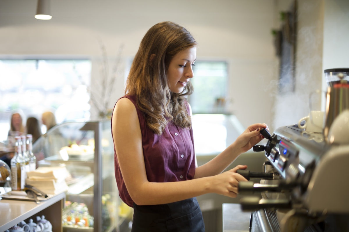 girl preparing coffee using coffee machine
