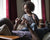 little girl sitting on father's stomach and learning maths