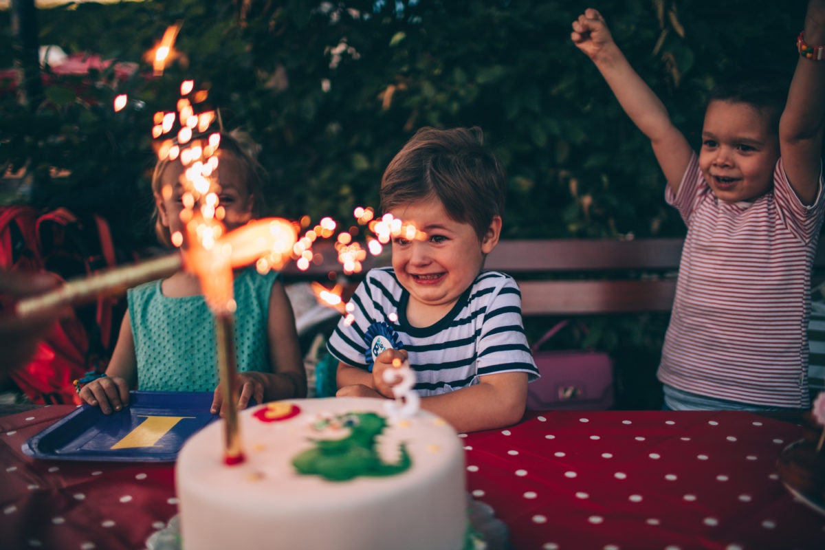 Young boy excited with birthday cake