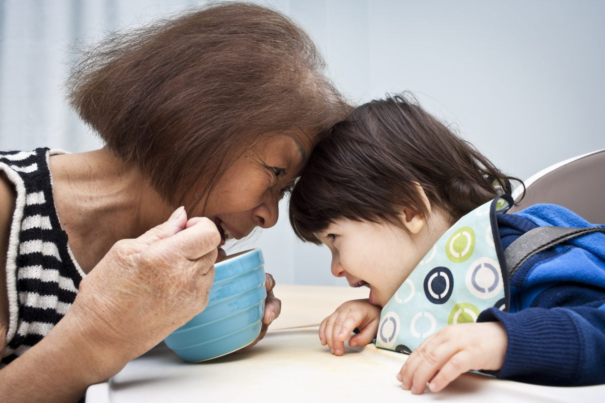A lady and a child touching head, lady holding bowl