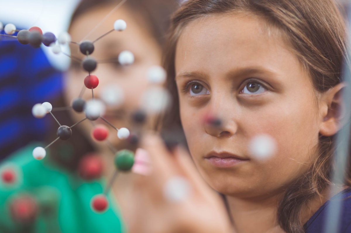 A girl looking at DNA helix at exhibition