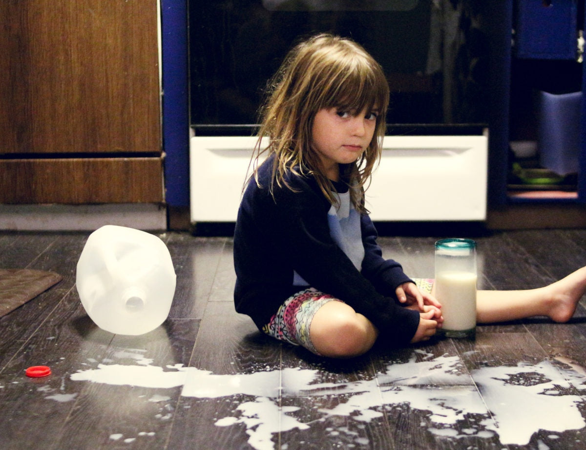 A child spiled milk all over the floor