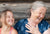 Cheerful young grand daughter and grand mother talking ,laughing at home