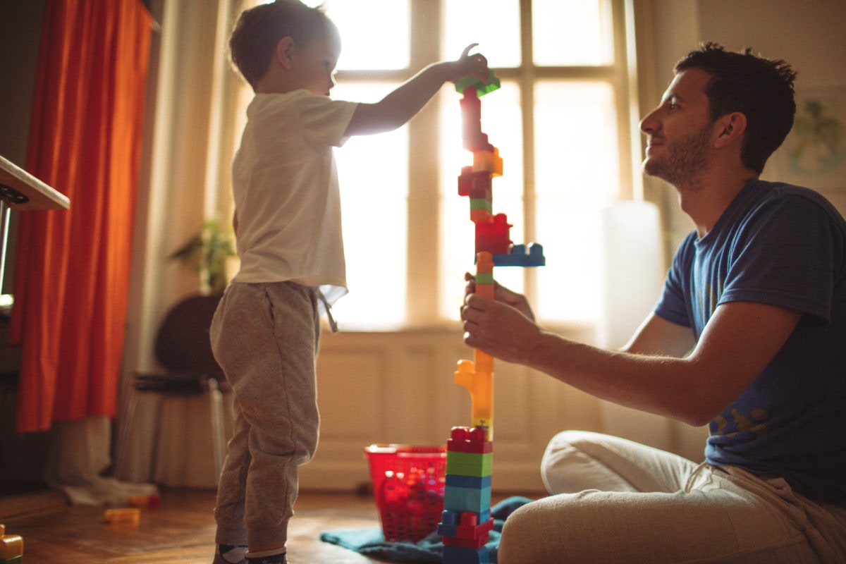 Father and son playing with building blocks together