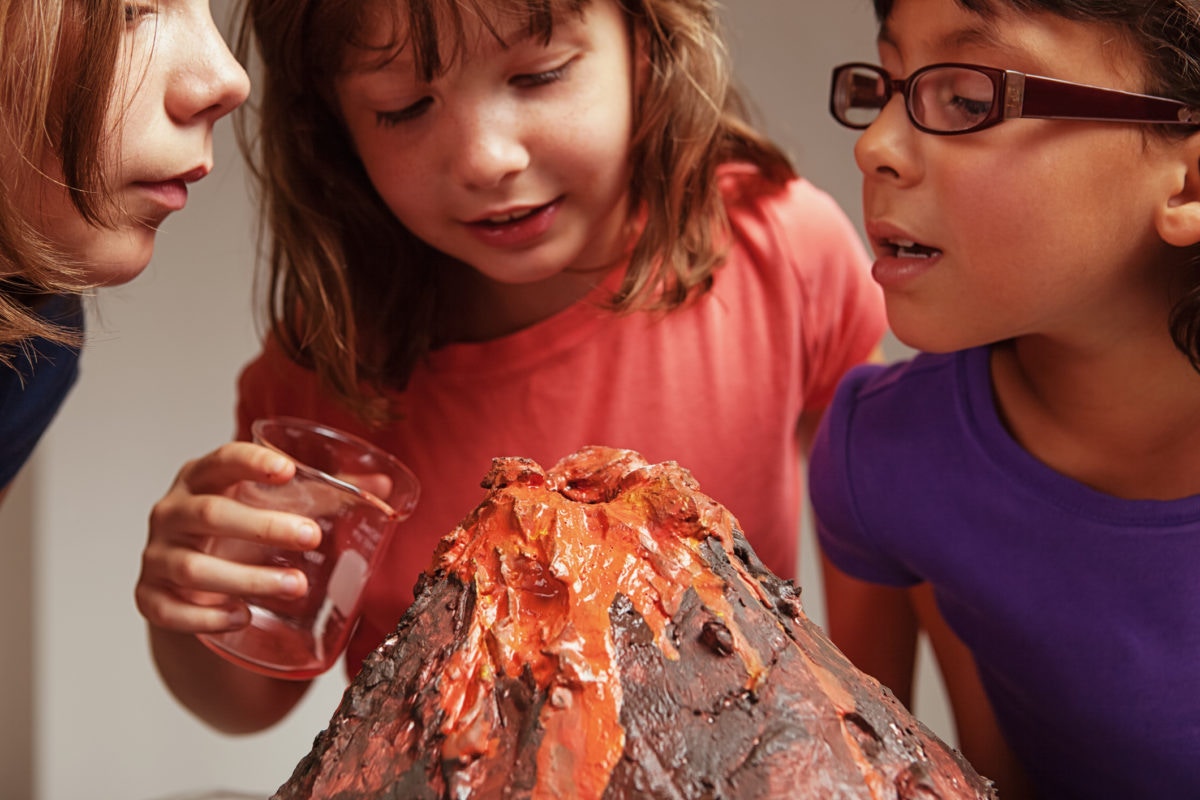 Young girls making volcano model