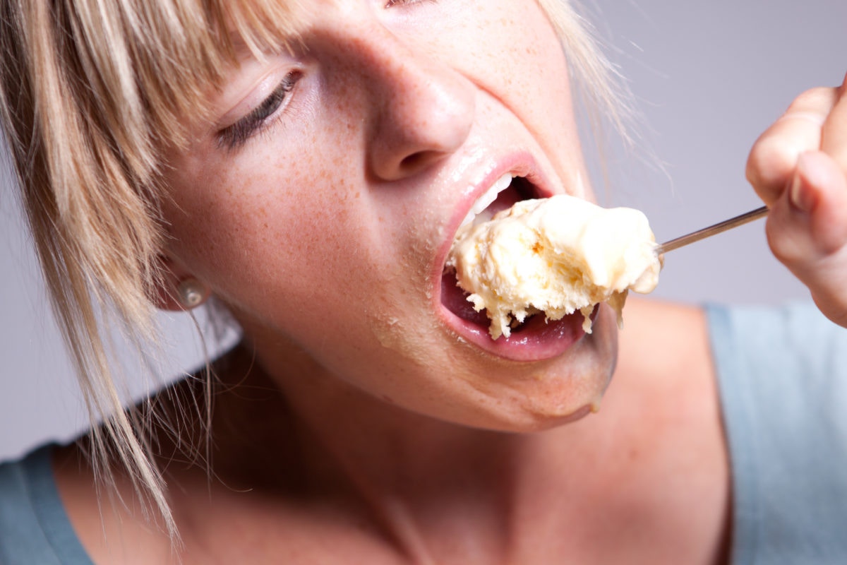 Woman eating spoon full of ice cream