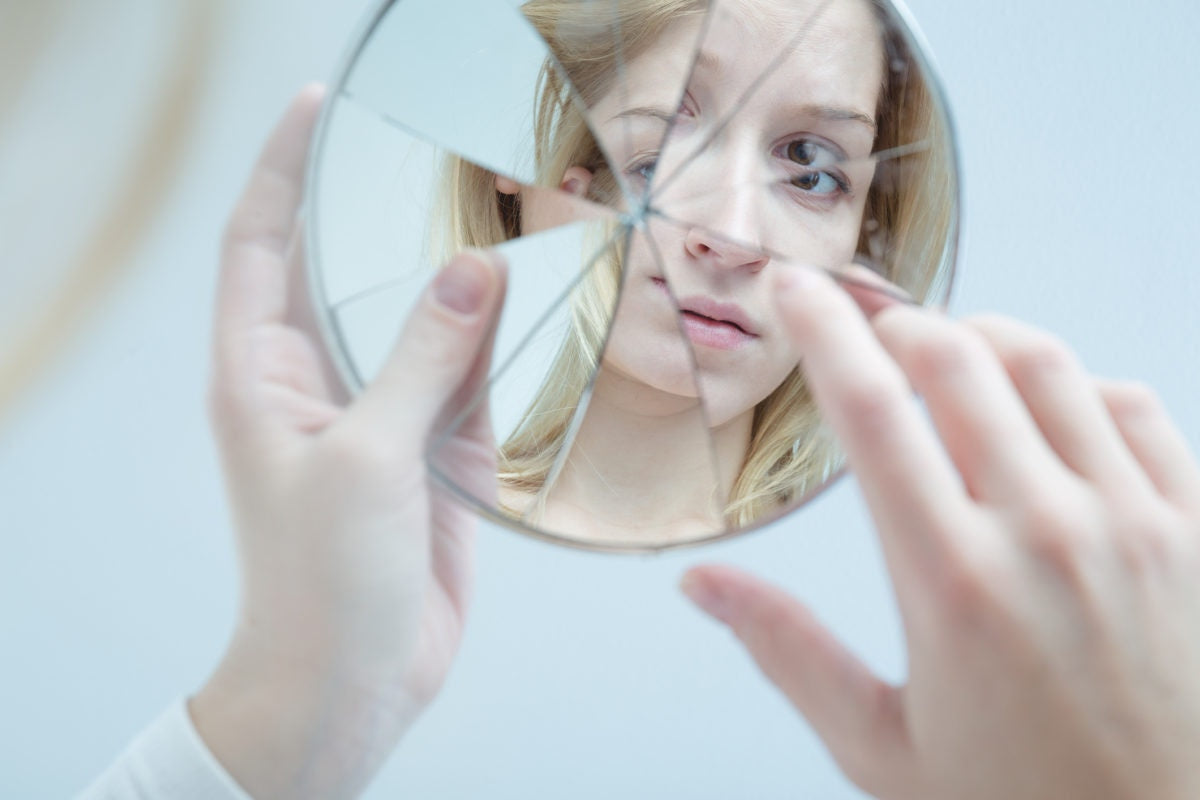woman face in broken mirror