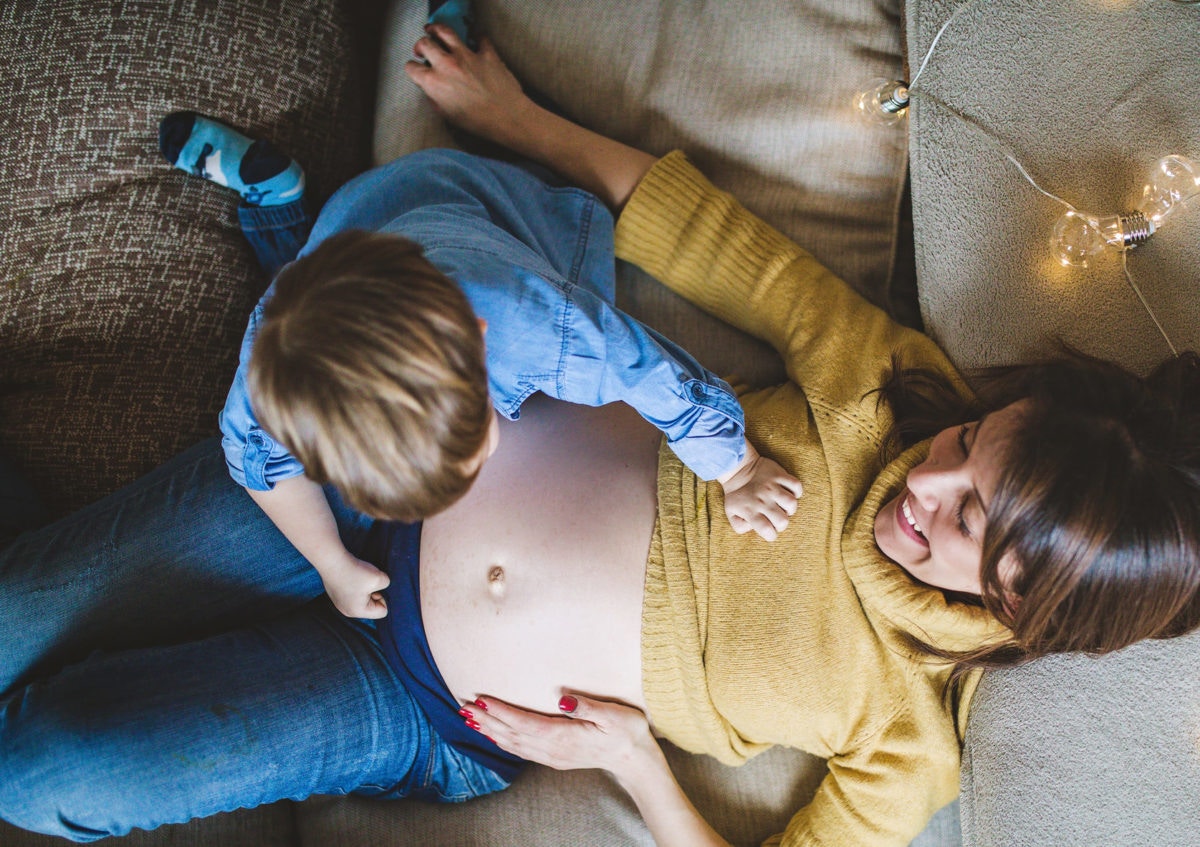 Little Boy Touching  Pregnant Mom's Belly