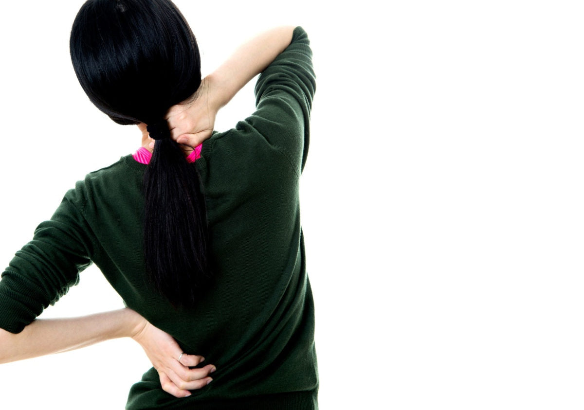 A girl is sitting behind with feeling back pain