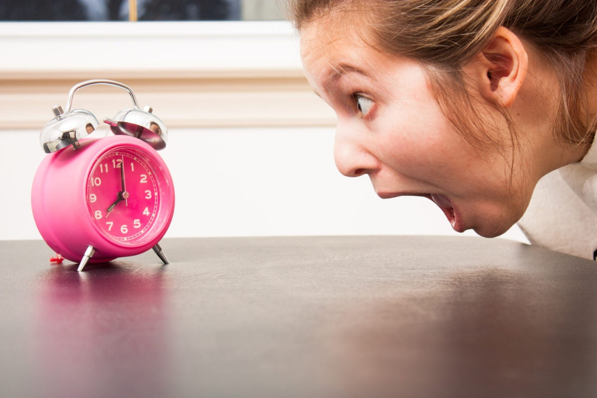 women is shouting by seeing the alarm clock