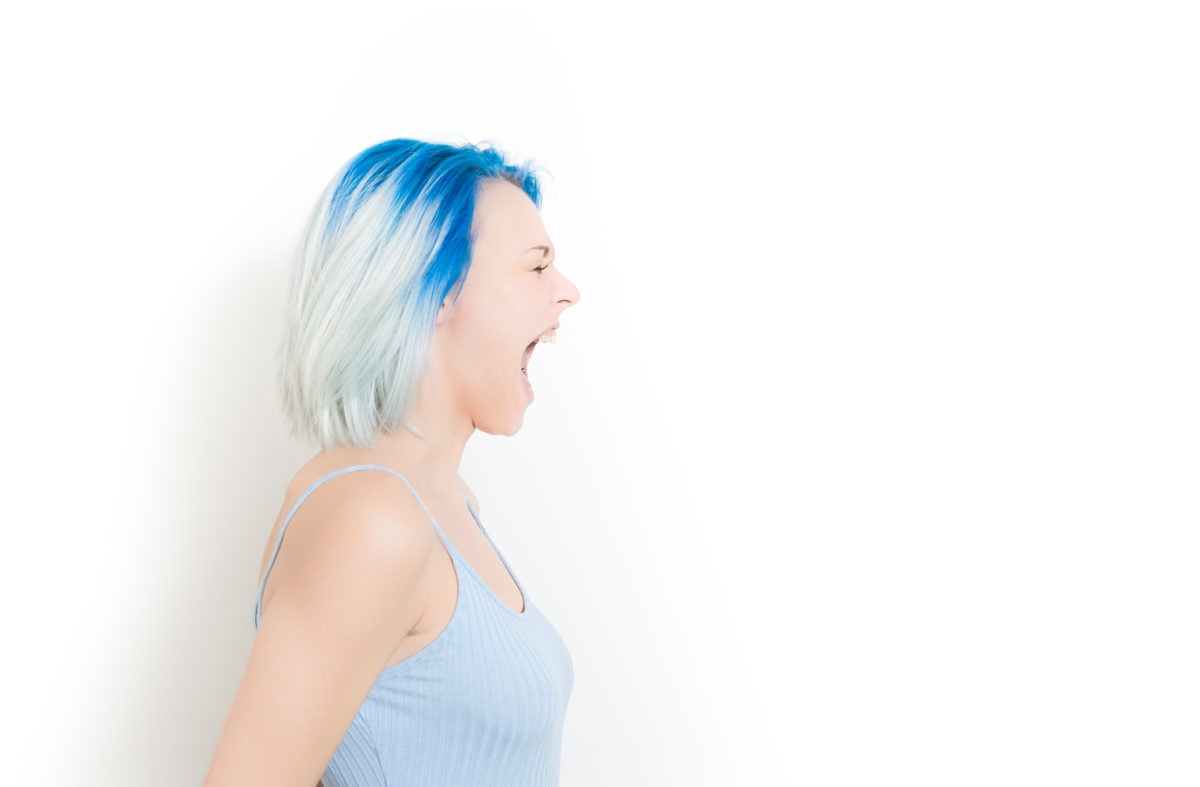 Woman with blue colored hair shouting