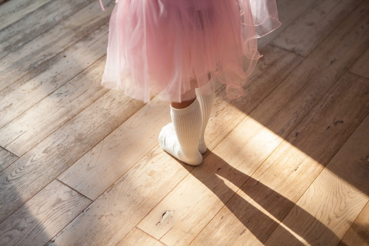 girl in a dusty pink skirt, white socks