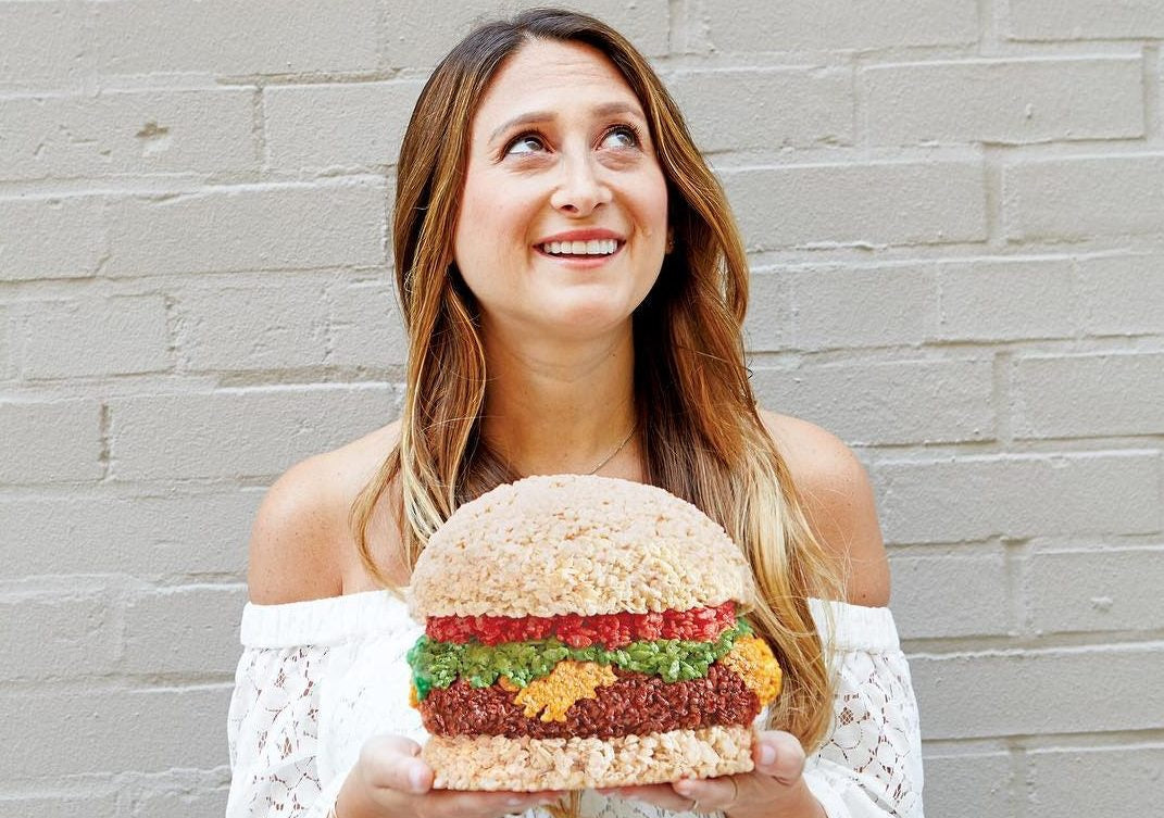 happy lady holding huge healthy burger